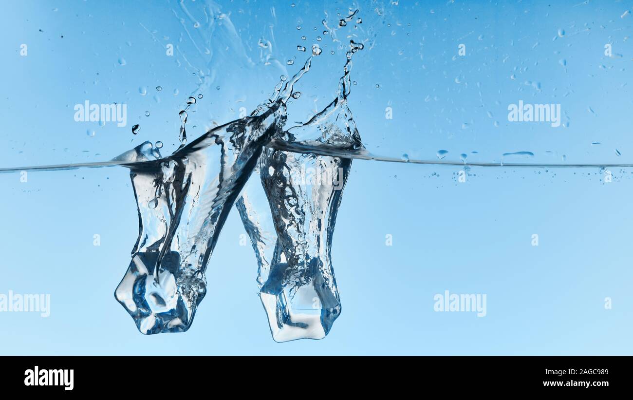 clear water with falling ice cubes and splash on blue background Stock ...