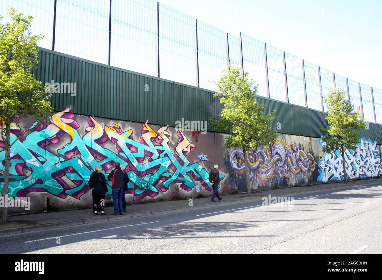 Colourful murals & graffiti on Peace wall,or Peace Line, running along Cupar Way in Belfast. It is one of the many separation barriers in N. Ireland Stock Photo