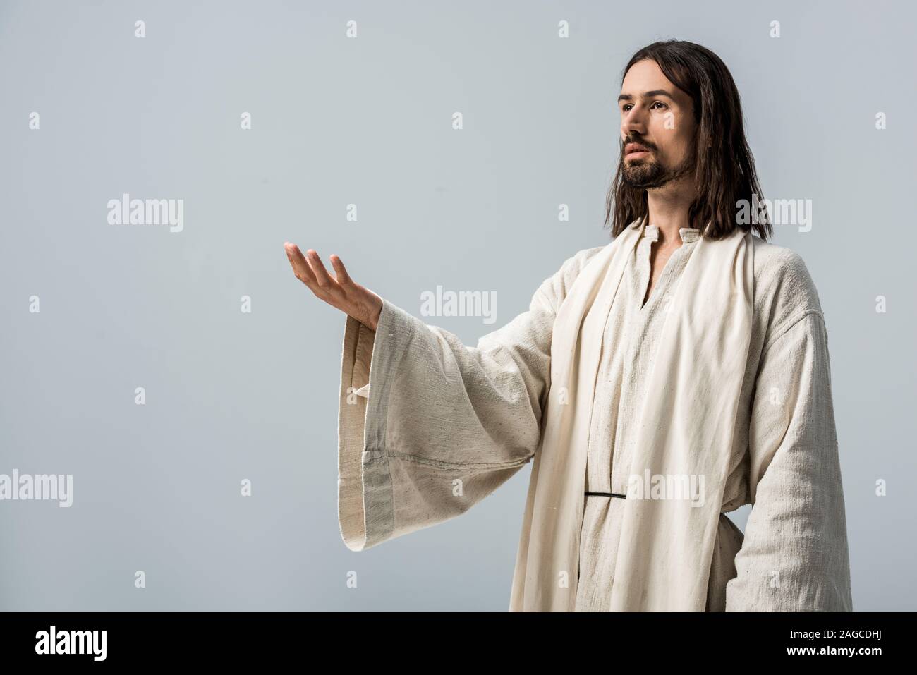 bearded religious man with outstretched hand isolated on grey Stock Photo