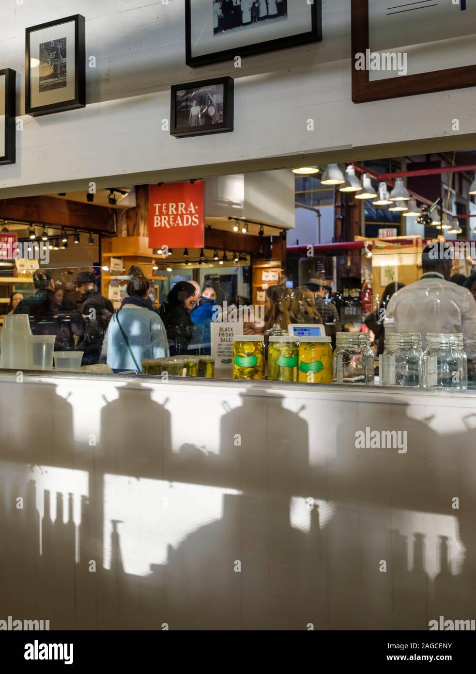 Late afternoon light filters through jars and product displays at the Granville Island Public Market in Vancouver, British Columbia Stock Photo
