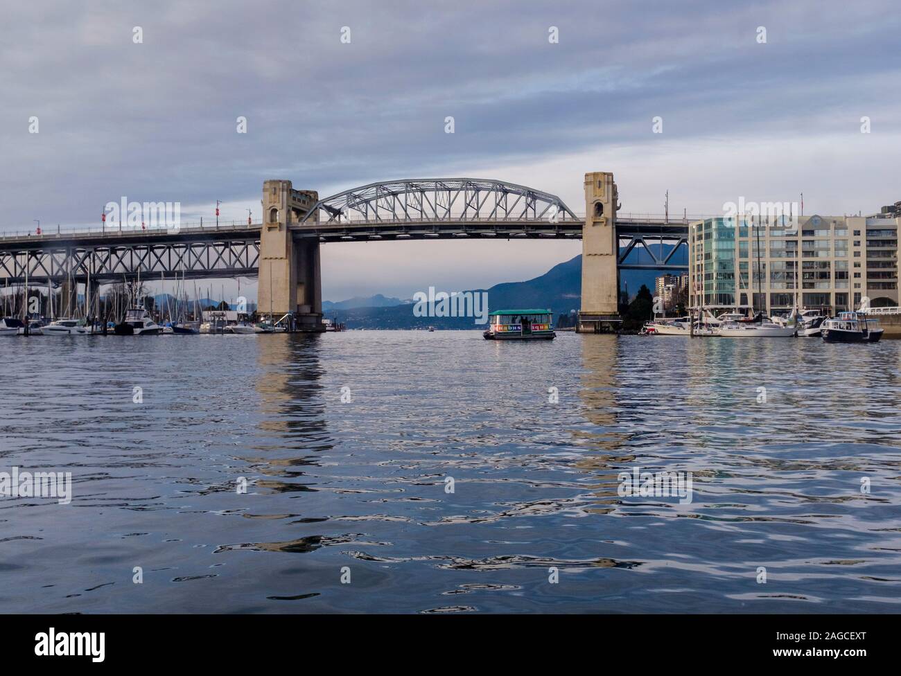 Late afternoon view of the Burrard Street Bridge from the calm waters ...