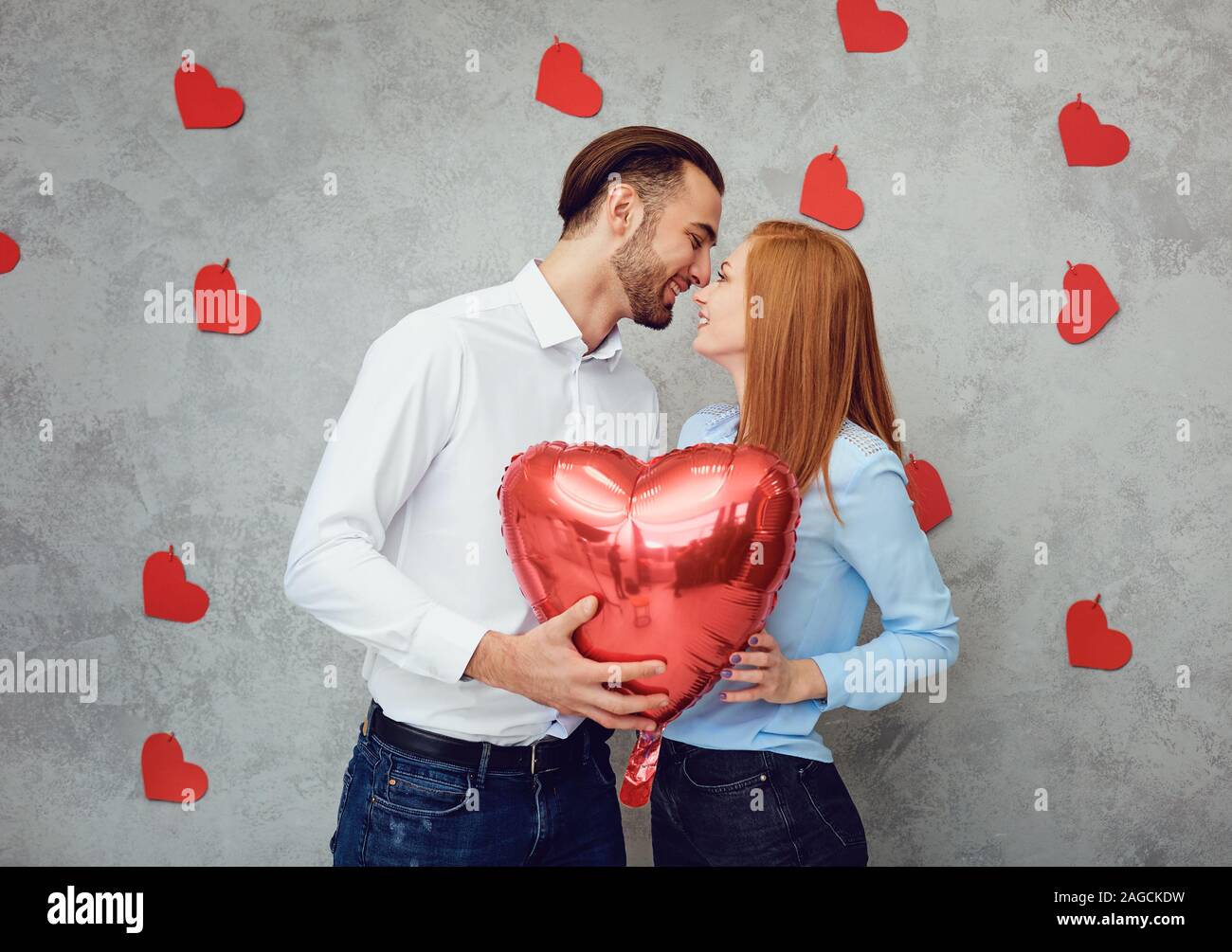 Cute couple with heart balloon Stock Photo - Alamy