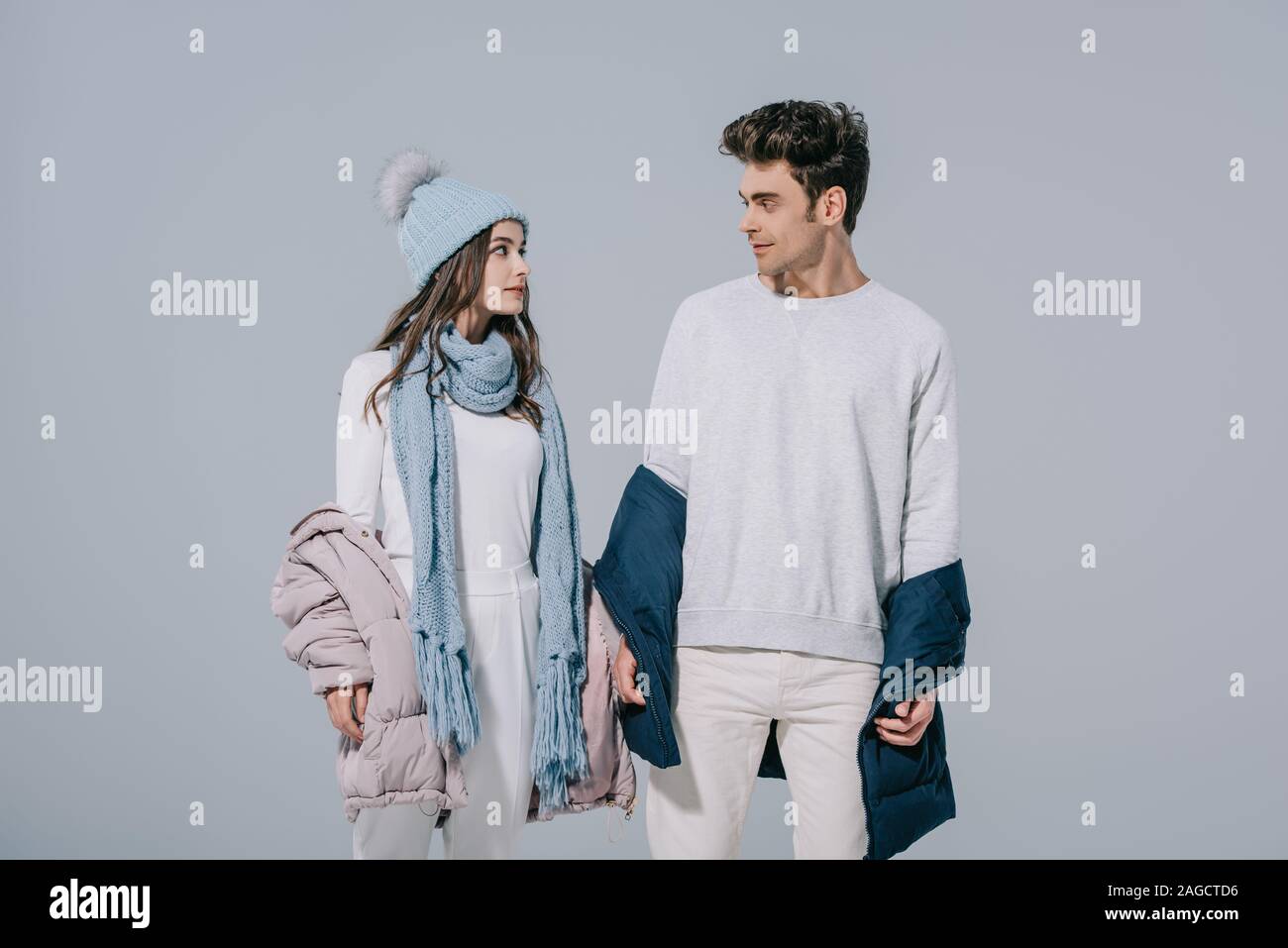 Beautiful Stylish Young Couple Posing In Warm Winter Outfit Isolated On Grey Stock Photo Alamy