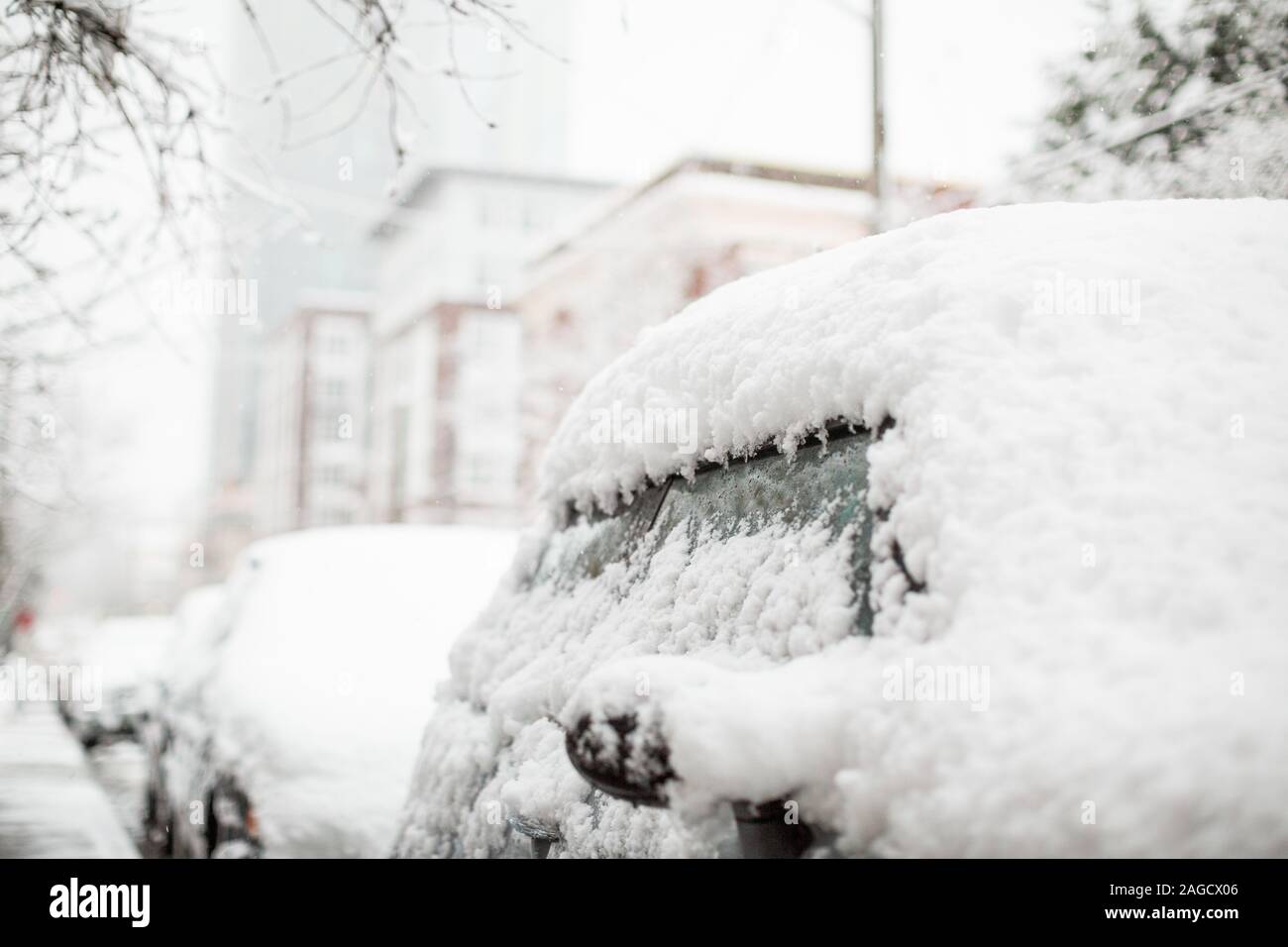 Black car parked in the street all covered with snow Stock Photo - Alamy