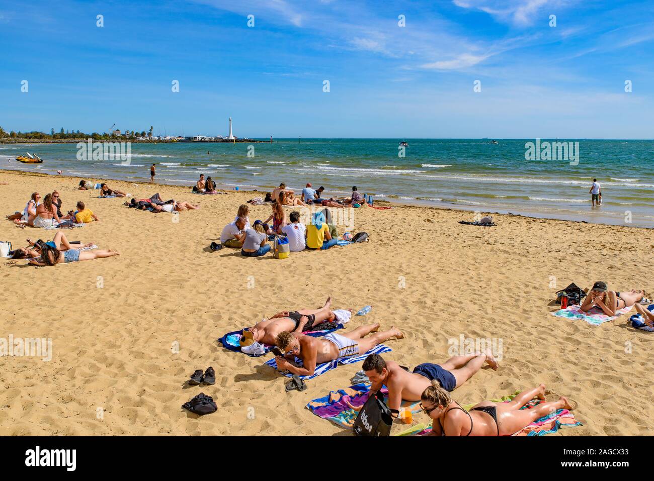 People enjoying sunbath at St Kilda Beach, the most famous beach in Melbourne, Australia Stock Photo