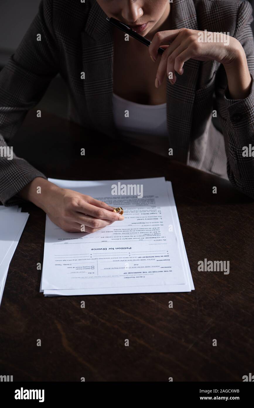 Partial File Signing partial view of woman in formal wear signing divorce documents Stock ...