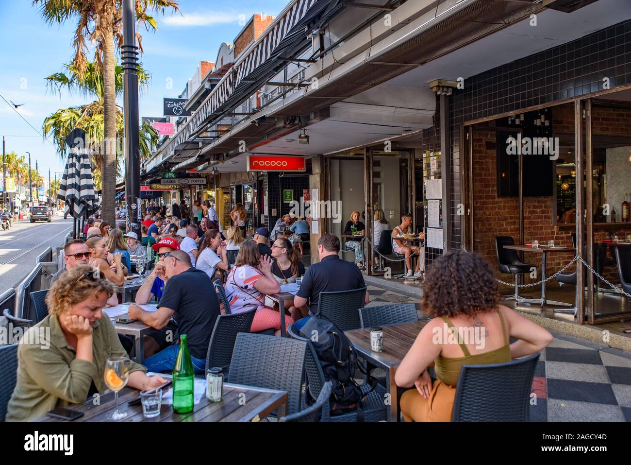 People enjoying food and drink at outdoor seats at St Kilda, Melbourne, Australia Stock Photo