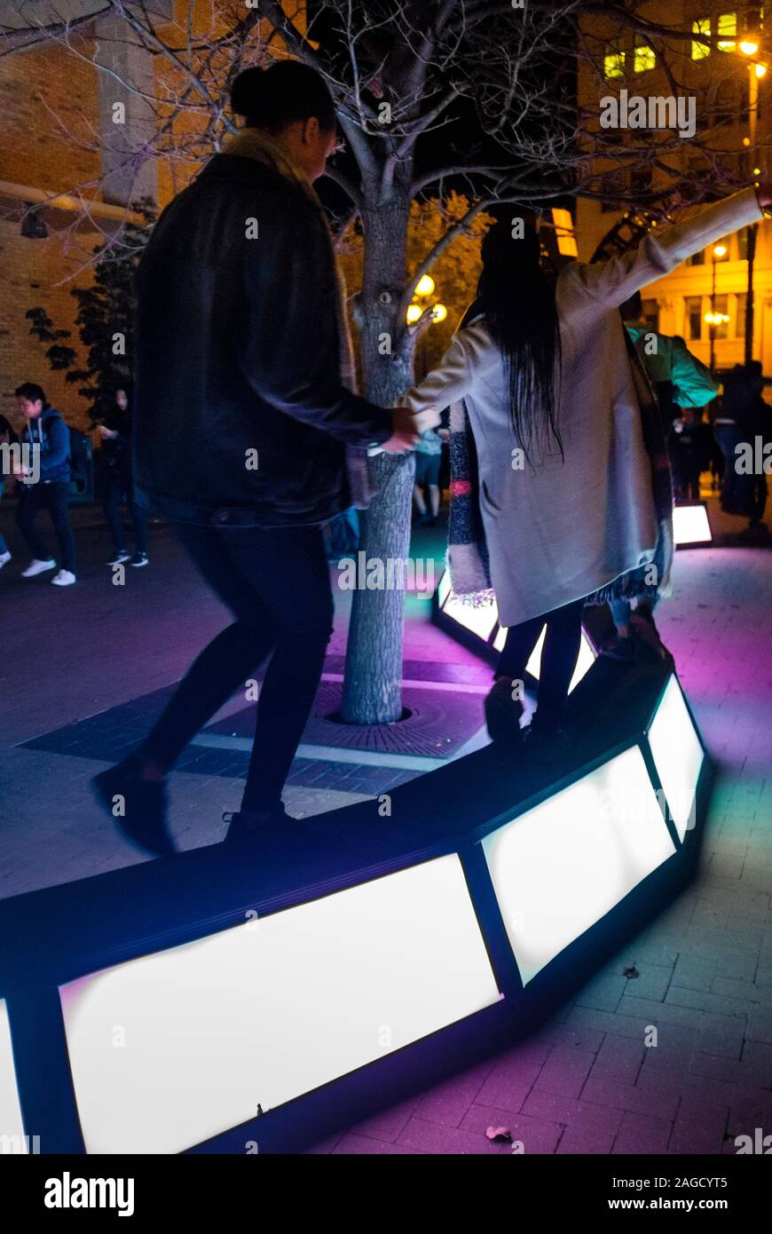 People interact with a winding path of lights at the creative Nuit