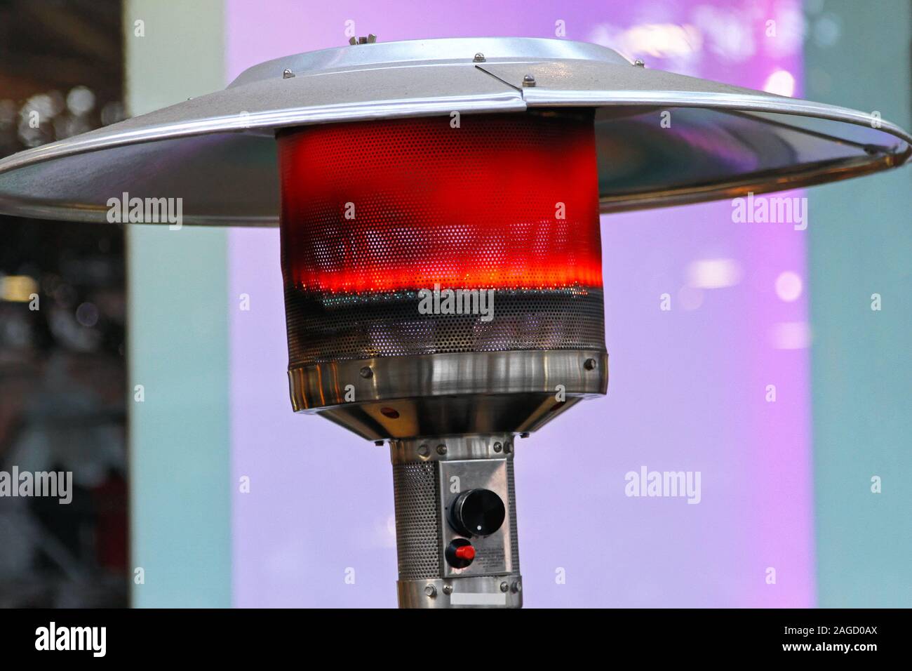 Outdoor gas heater patio lamp burning red Stock Photo Alamy