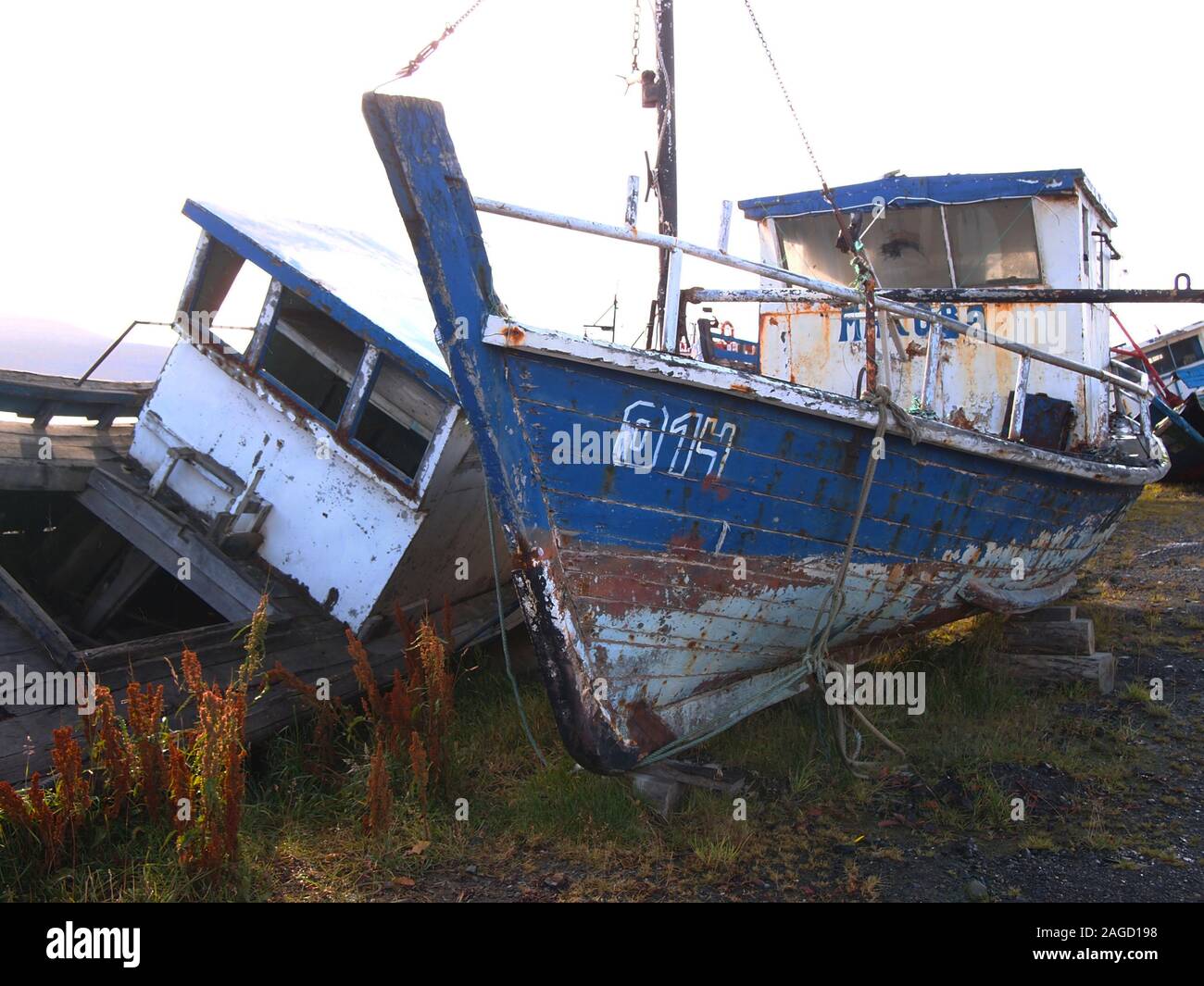 Scrapped old artisanal fishing vessels in a ship graveyard near Puerto Williams (Chile), the world' southernmost village Stock Photo