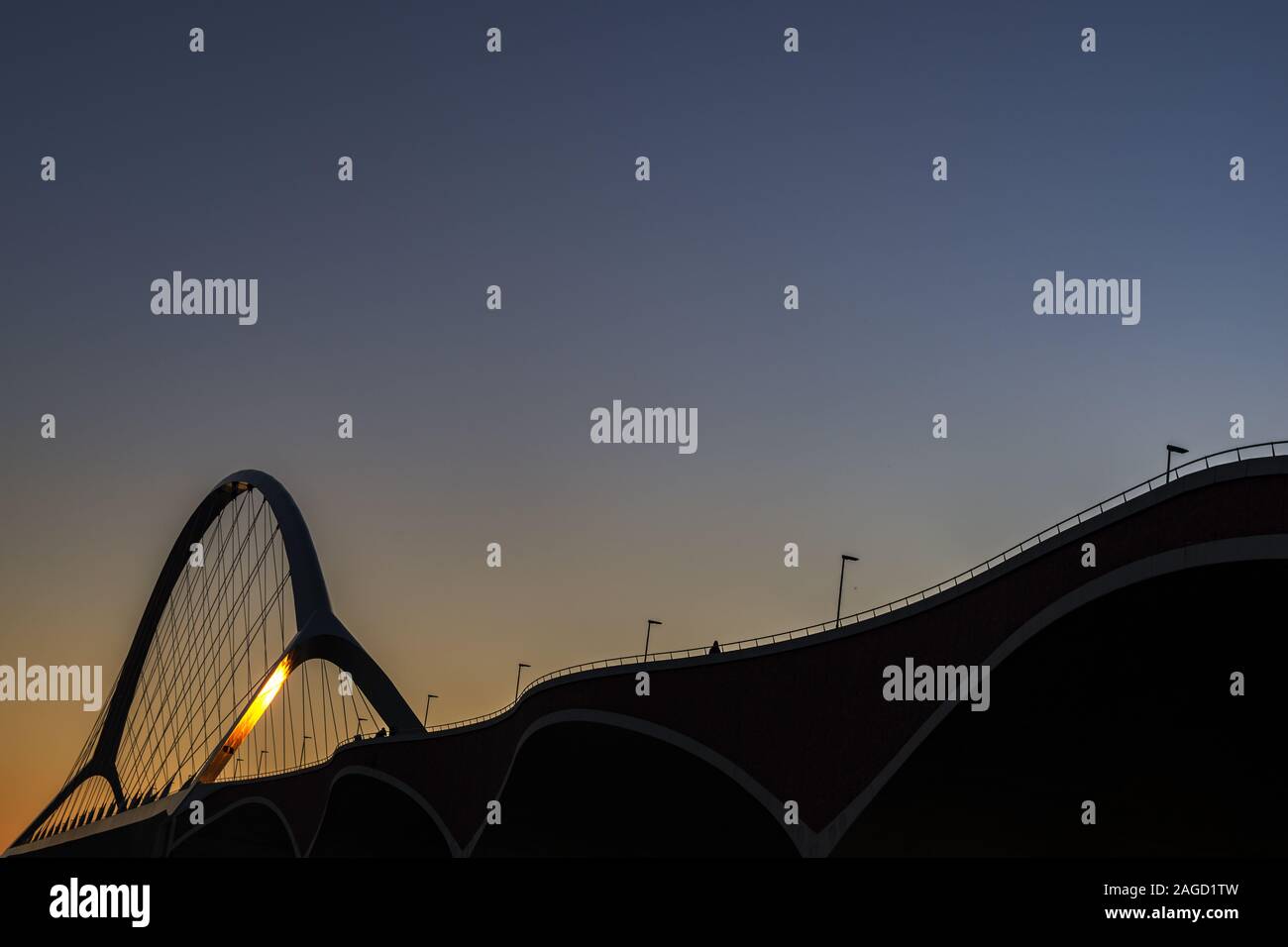 Crossing bridge in Nijmegen in the Netherlands under a blue sky during sunset Stock Photo