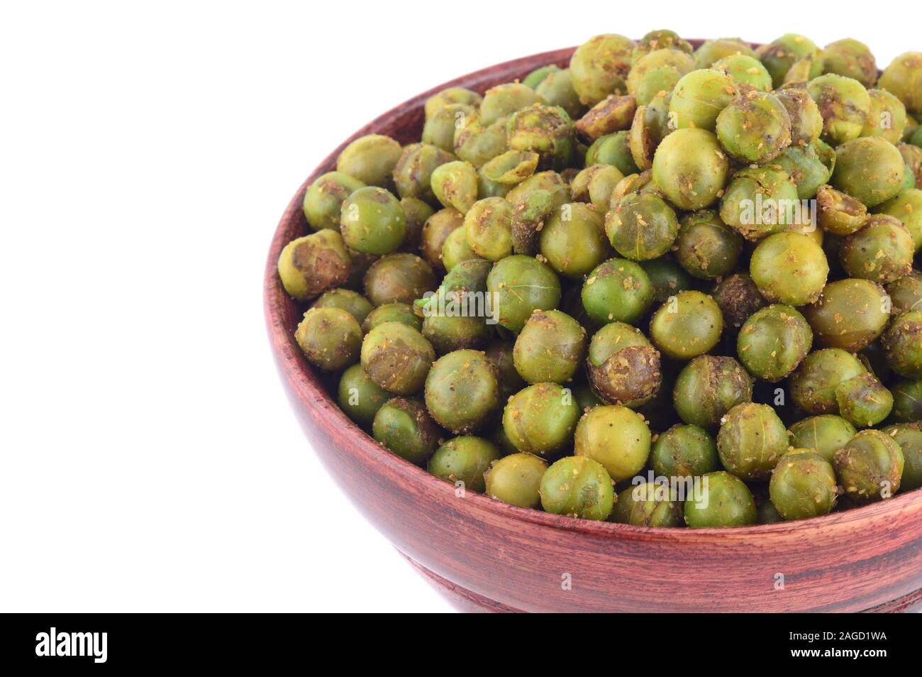 Spiced fried green peas {chatpata matar} Indian snack. Dried salted green peas in wooden bowl