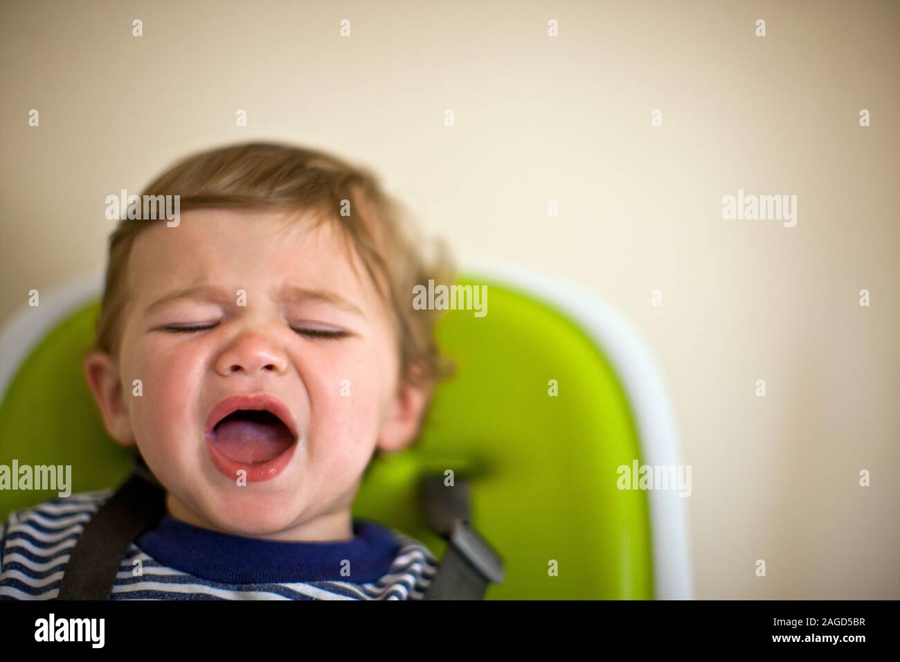 Young toddler with his eyes closed and his mouth open Stock Photo Alamy