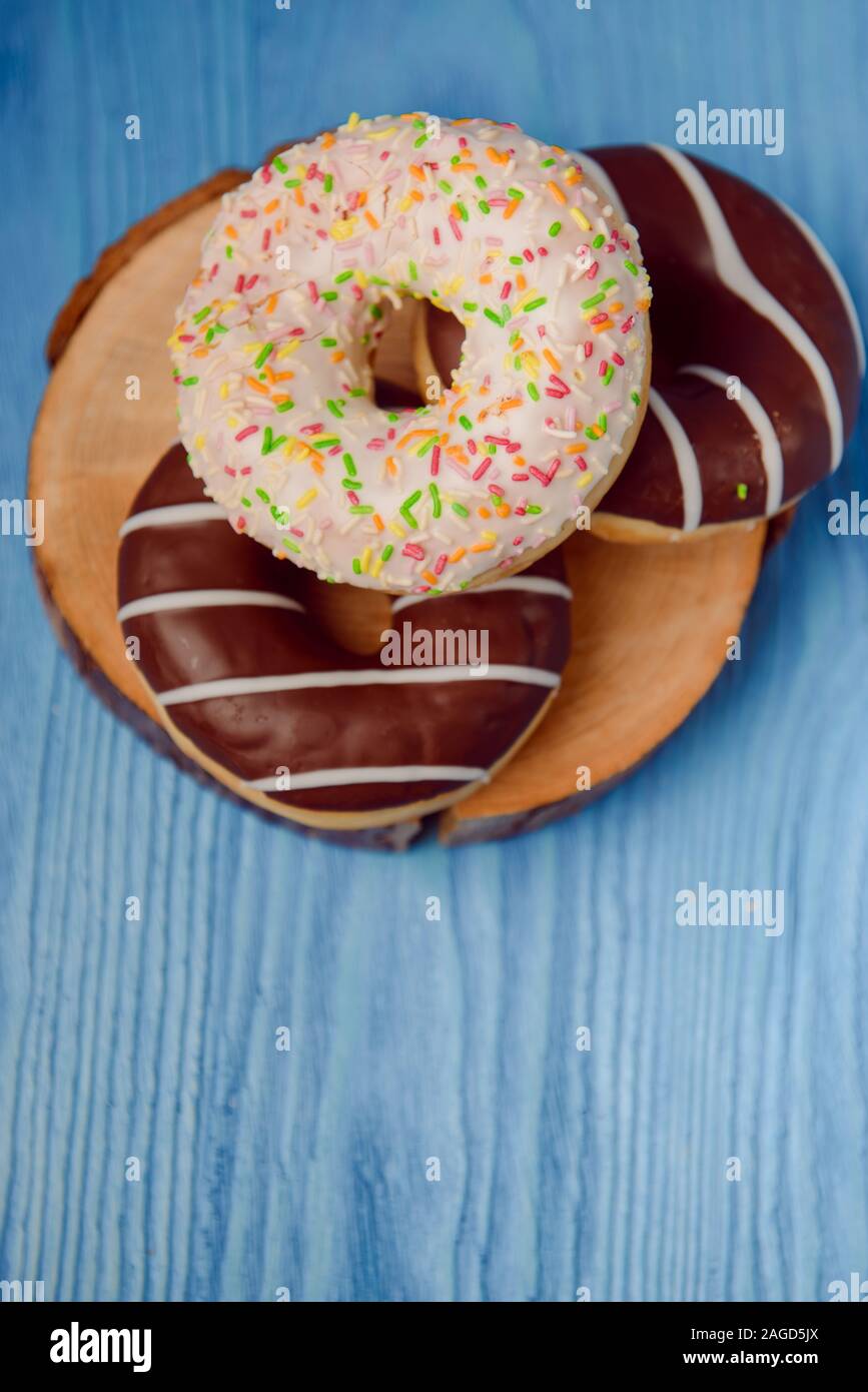 donuts lying on the table. blue background. Stock Photo
