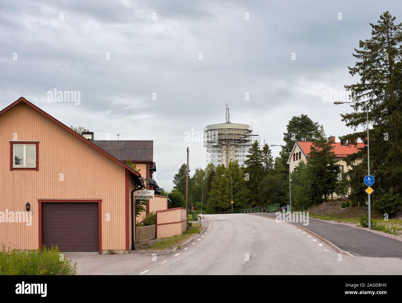 Road, some houses and a water tower construction near Gävle, Sweden Stock Photo