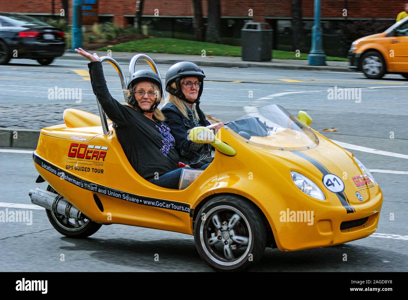 Middle-aged women cruising around in GoCar three wheeler in San Francisco, United States of America Stock Photo