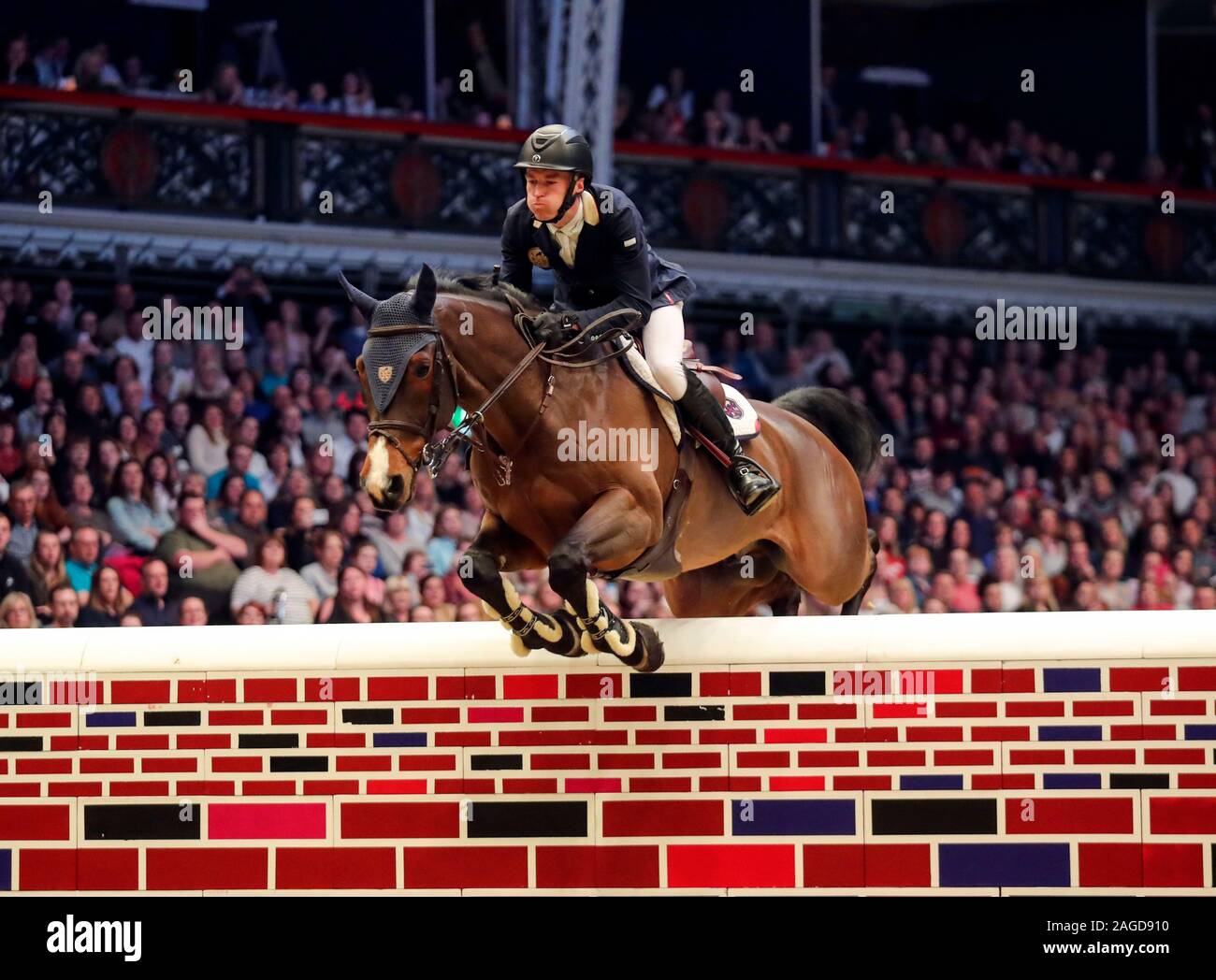 William Whitaker riding RMF Charly competes in the Cayenne Puissance during day three of The London International Horse Show at London Olympia. Stock Photo