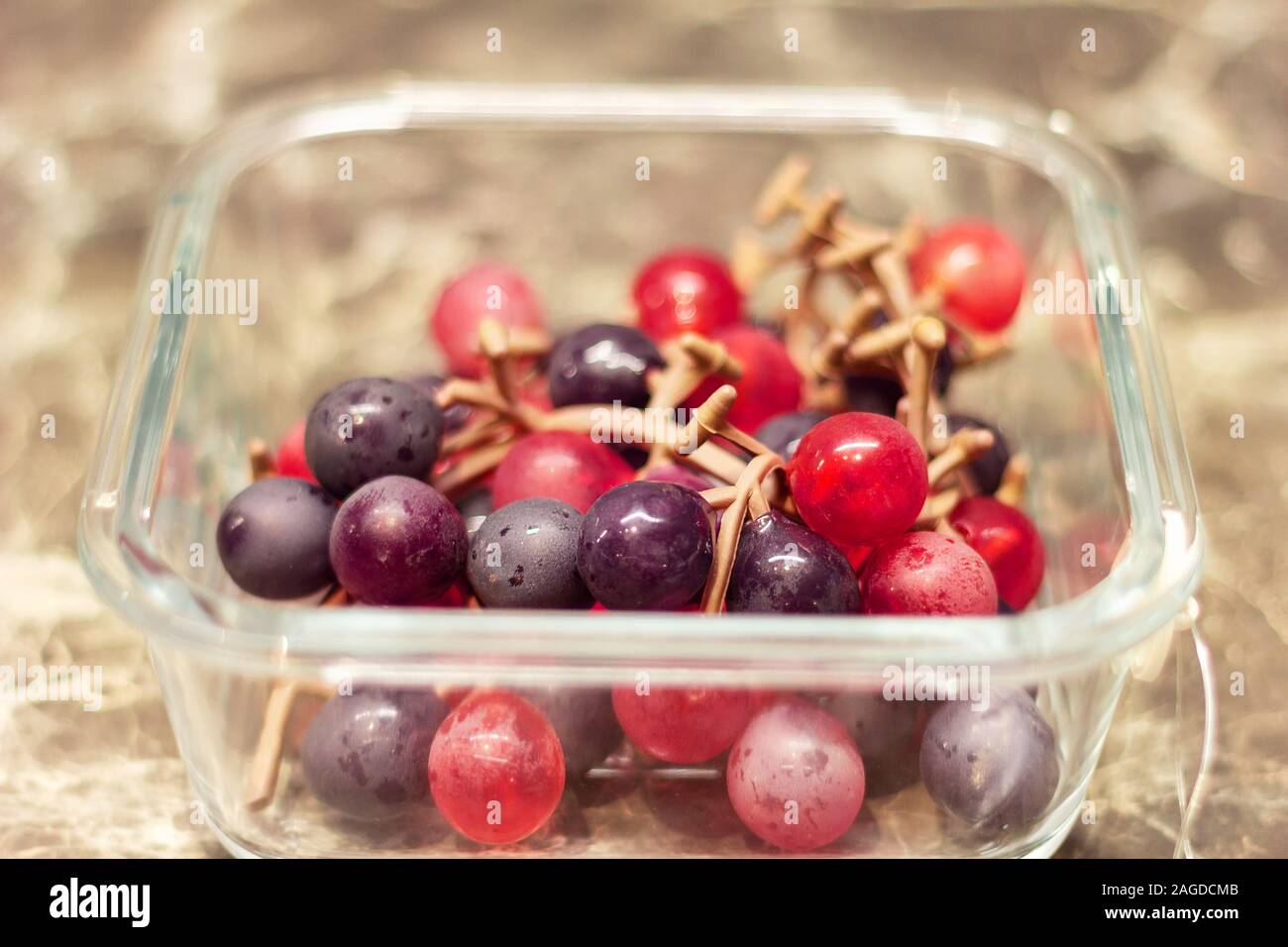 box for food storage in the refrigerator. artificial grapes Stock Photo