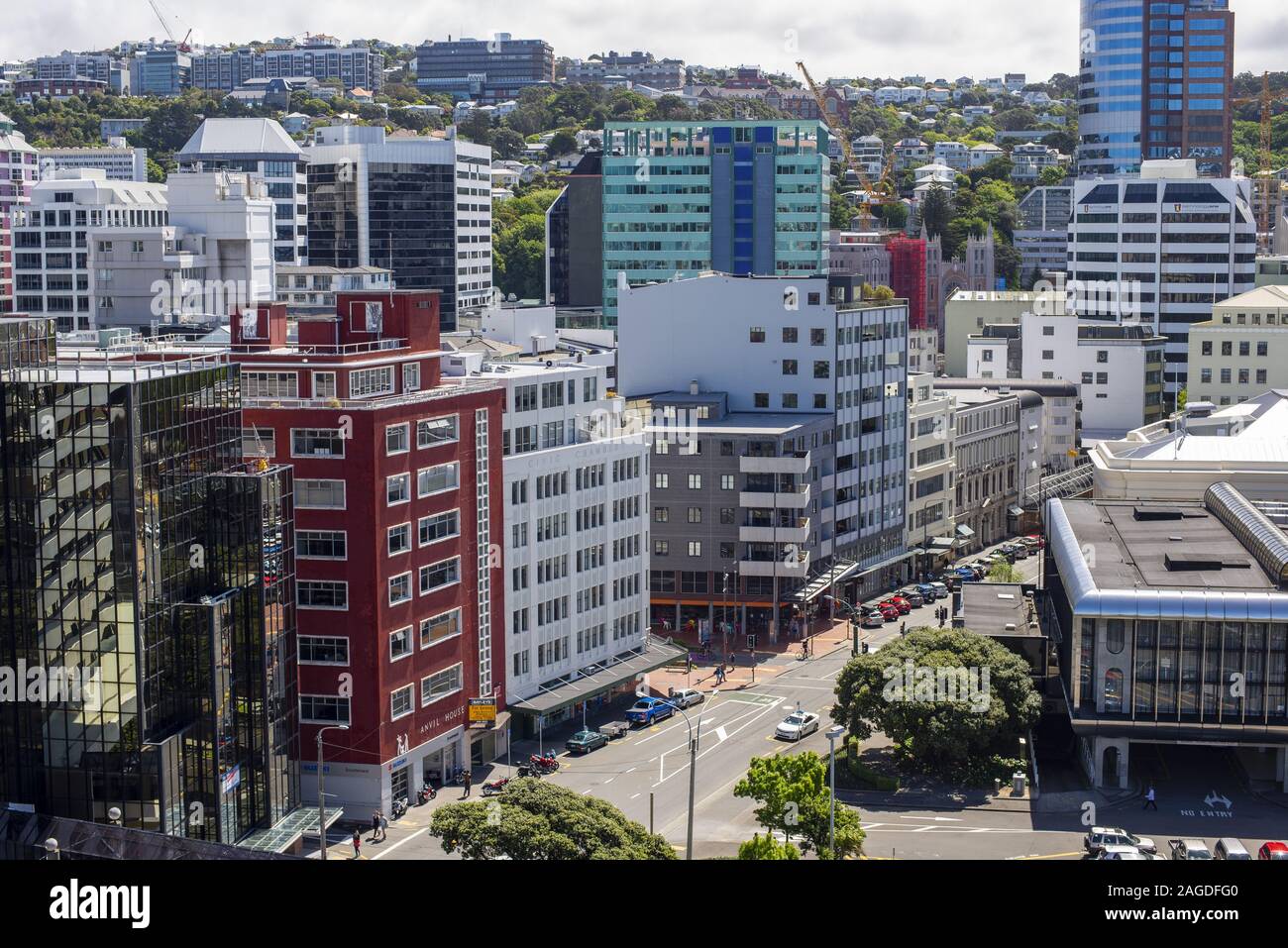 High shot of modern colorful buildings on roads surrounded by greenery in New Zealand Stock Photo