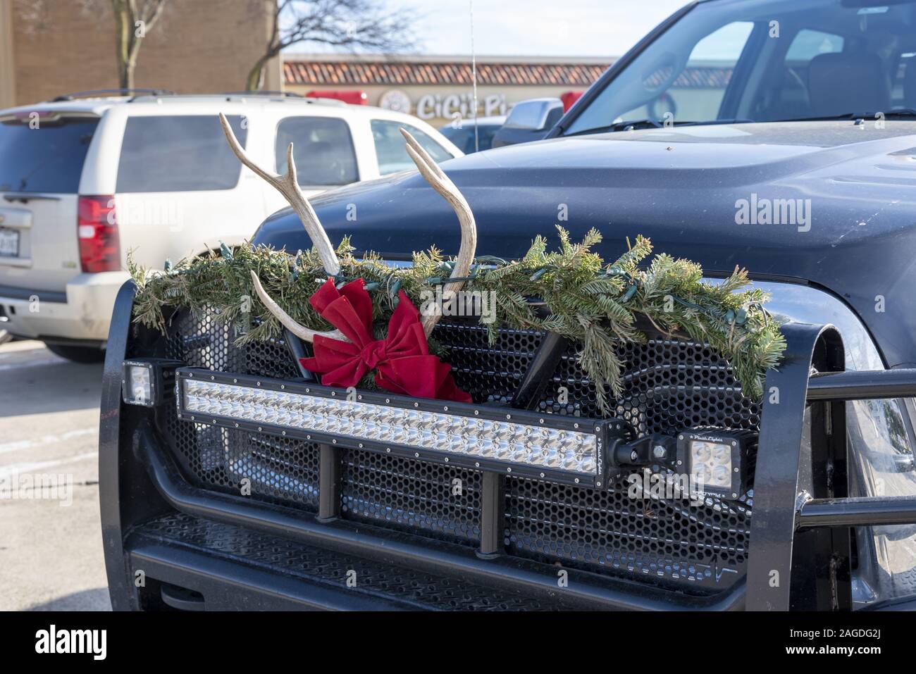 DALLAS, UNITED STATES - Dec 23, 2018: Dallas Texas USA, December 23 2018. Preston Center . The decorated front of a black ford truck with christmas wr Stock Photo
