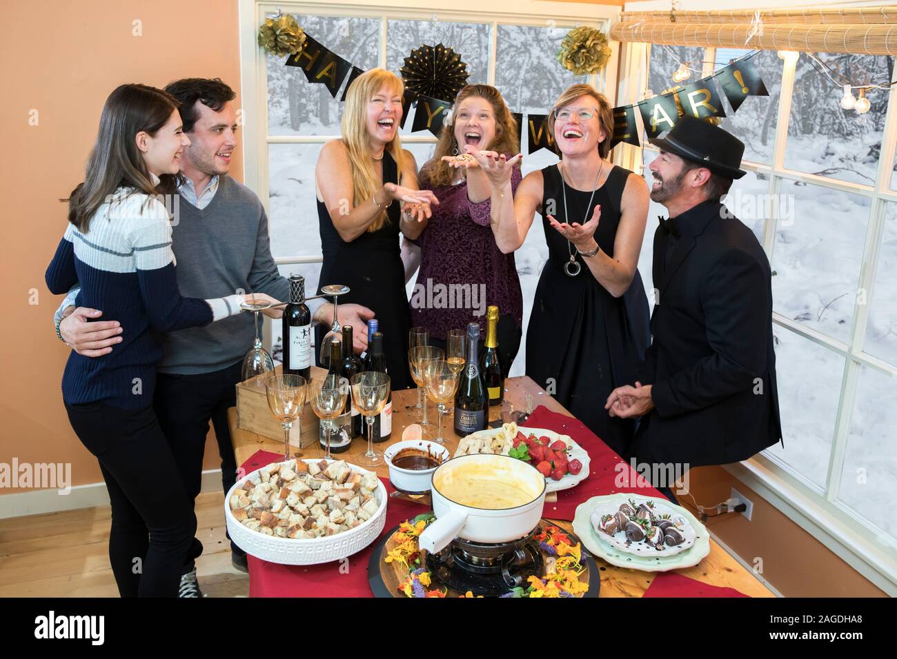 partygoers throwing confetti at New Year's party Stock Photo Alamy