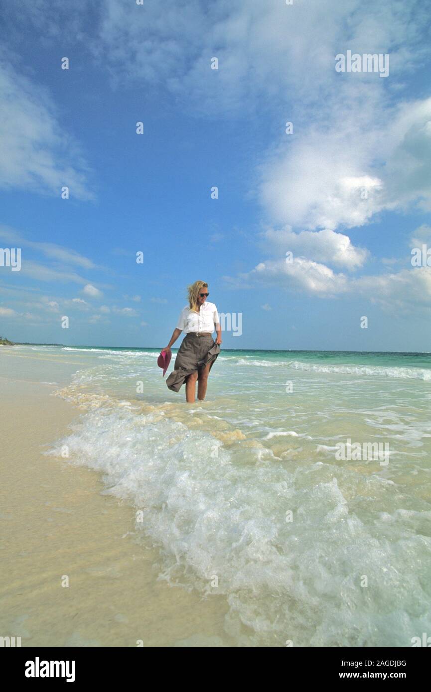 Woman walks the beach in Mexico Stock Photo