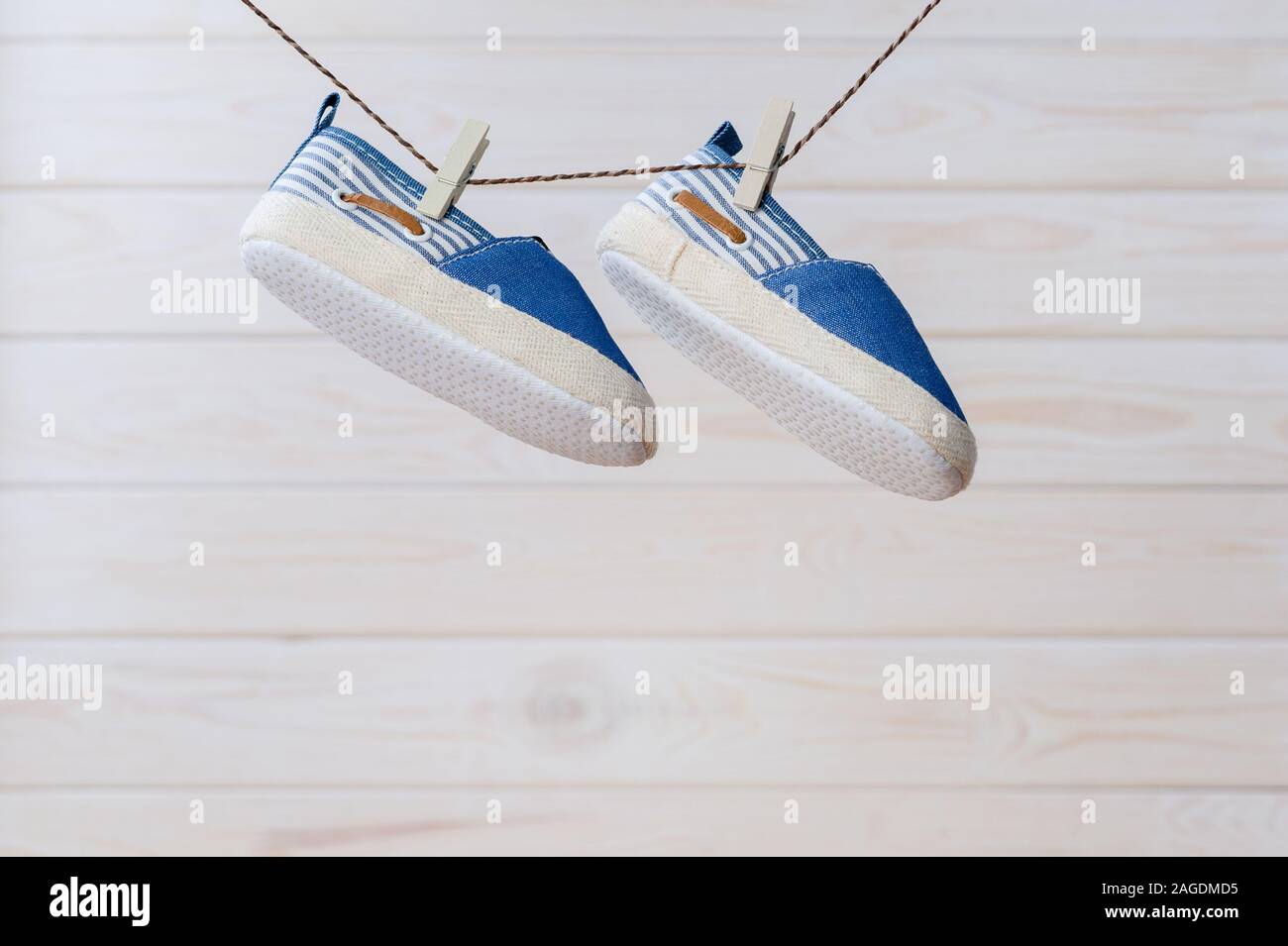 closeup little shoes for baby hanging on clothesline Stock Photo Alamy