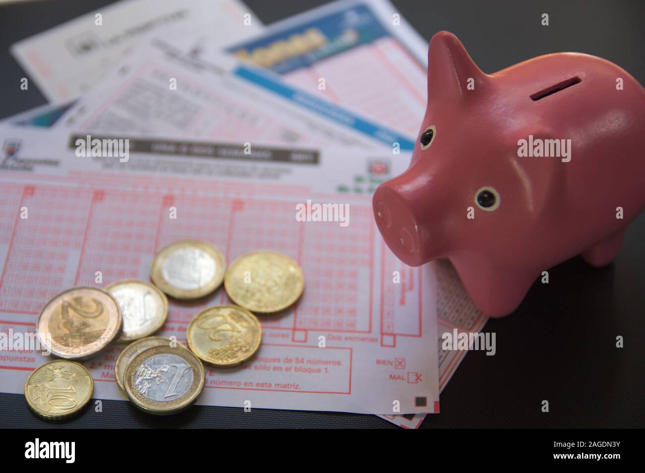 A piggy bank on a ticket of several lotteries of the Spanish state next
