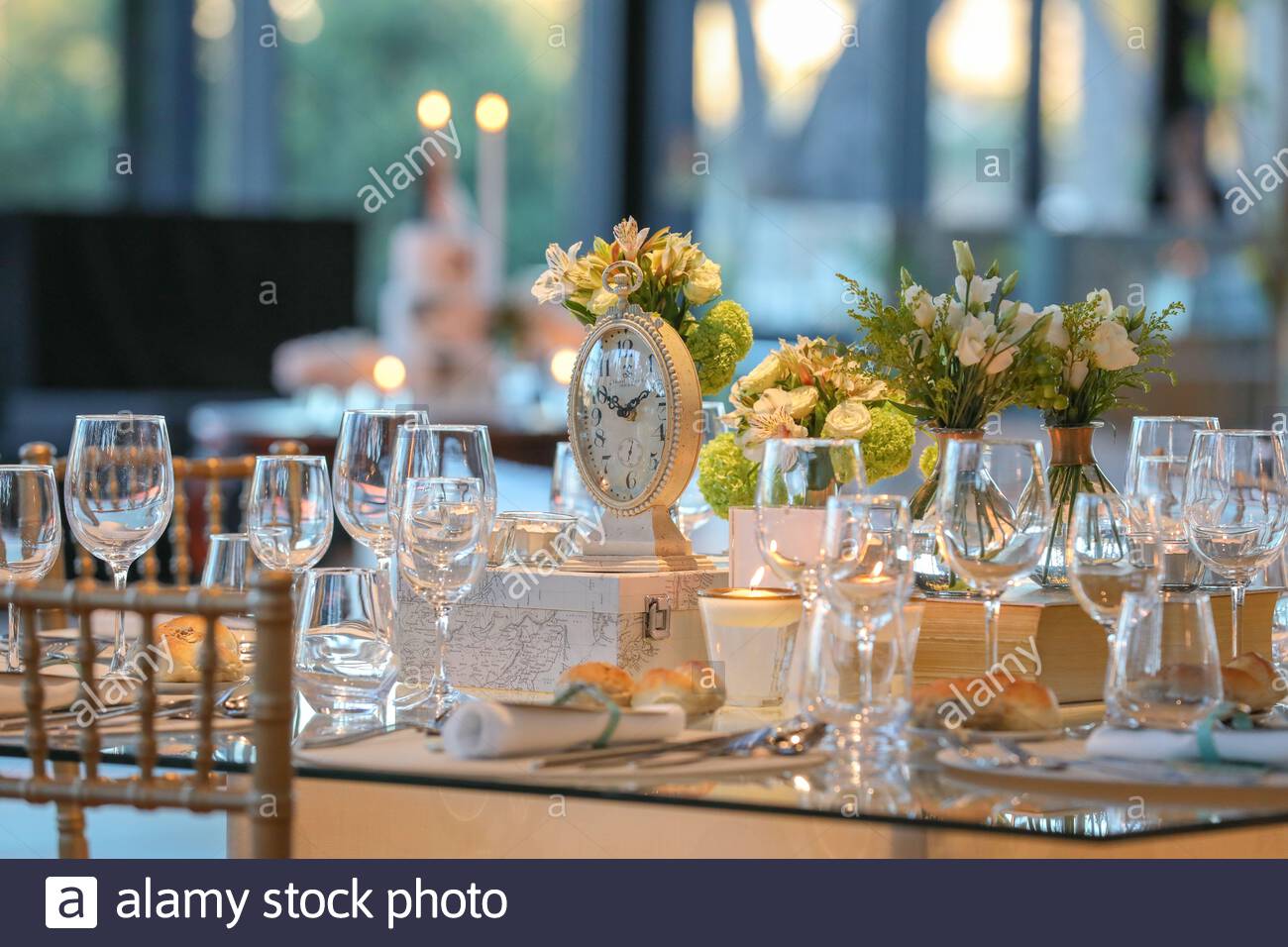A Beautiful Wedding Table Setting With Glass Cups And Floral