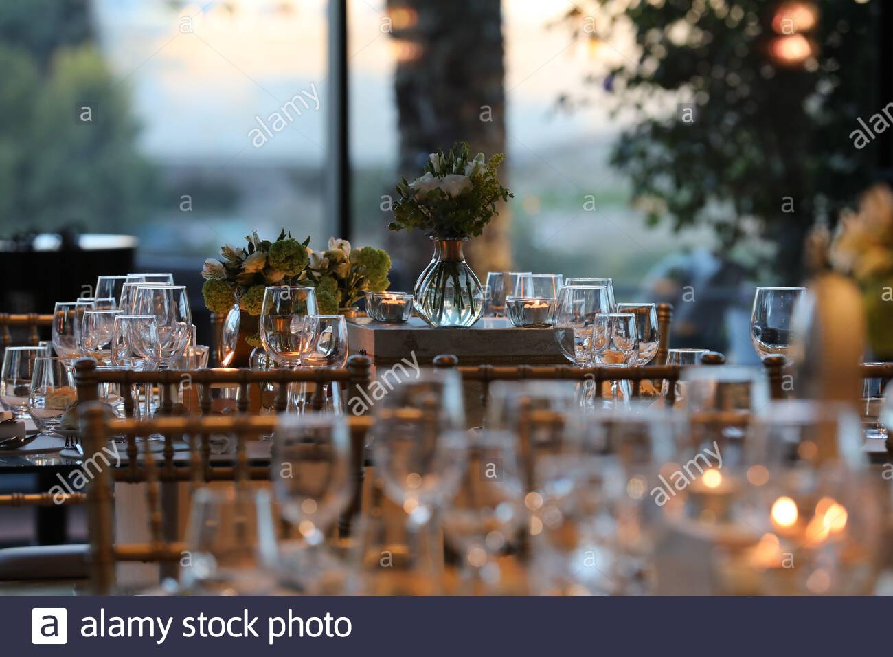 A Beautiful Wedding Table Setting With Glass Cups And Floral