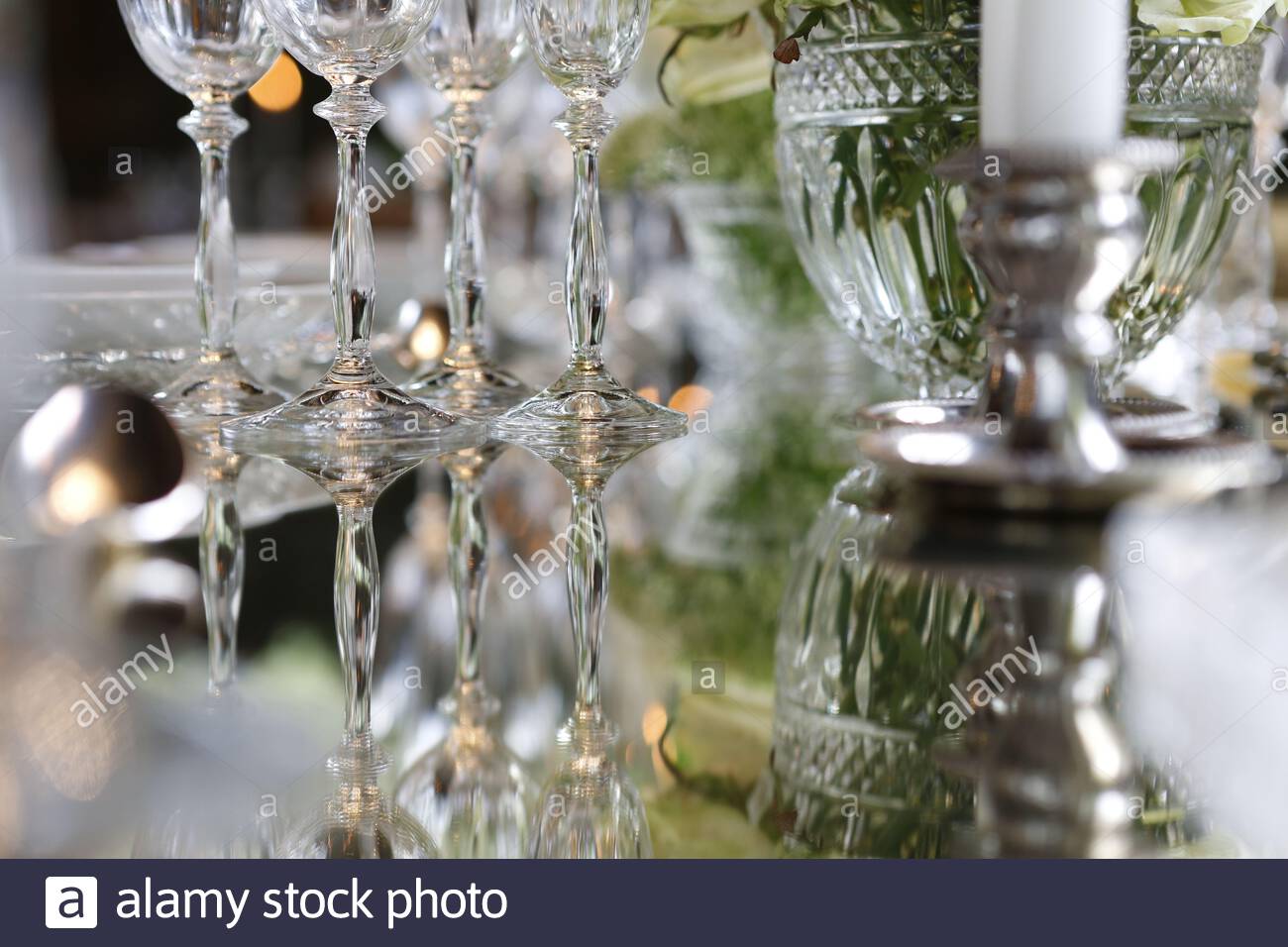 A Beautiful Wedding Table Setting With Glass Cups And Floral