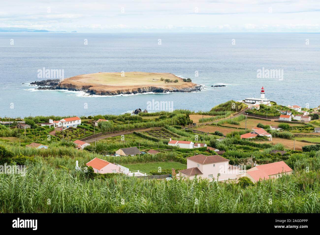 View of the Farol da Ponta do Topo and Ilhéu do Topo which look out over the Atlantic Ocean to the island of Terceira in the Azores archipelago. Stock Photo