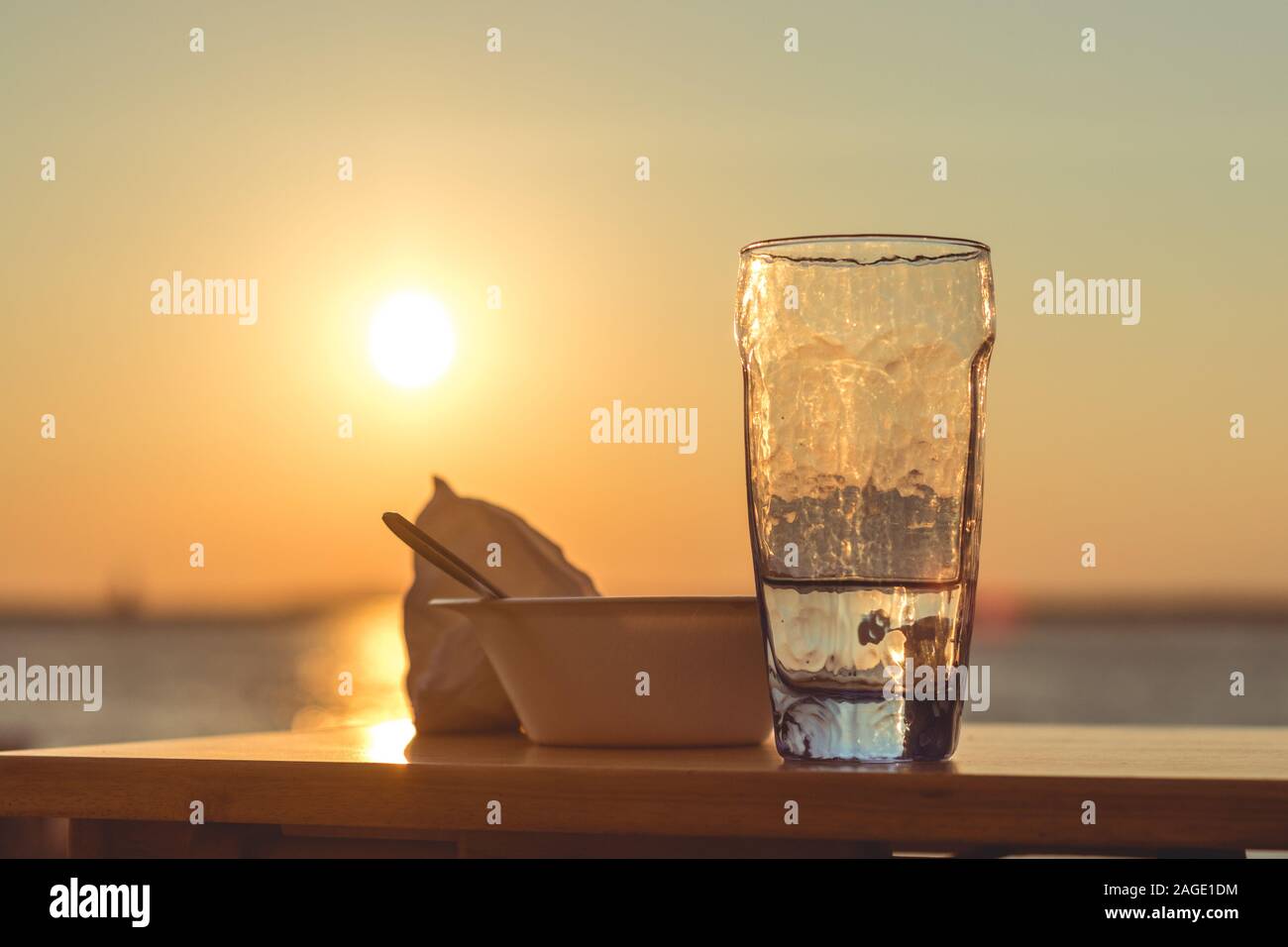 Glass Cup Filled With Water And A Bowl On A Table With The Beautiful View Of Sunset In Background Stock Photo Alamy Glass Cup Filled With Water And A Bowl On A Table With The Beautiful View Of Sunset In Background Stock Photo Alamy