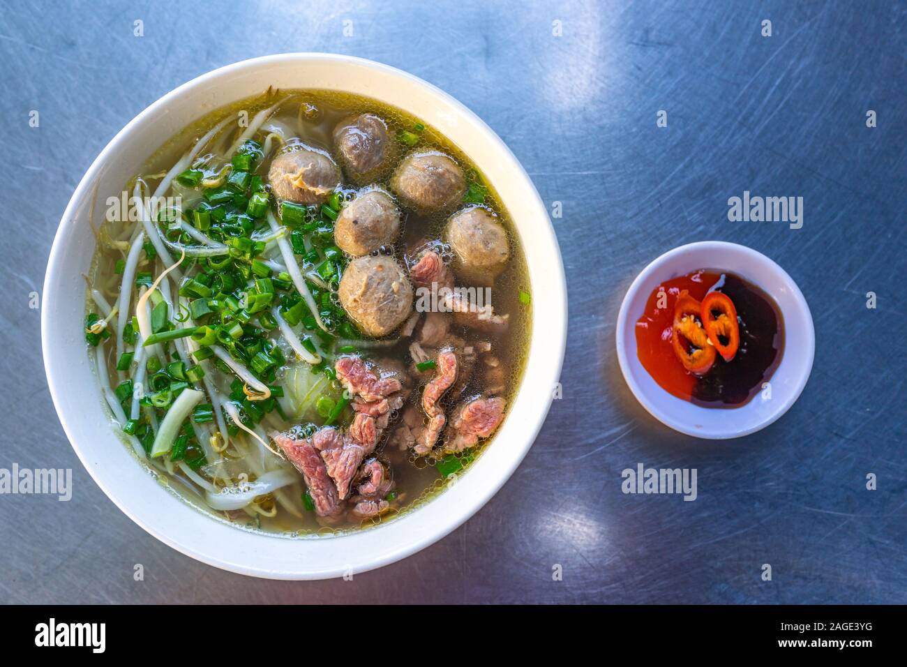 Overhead view of beef Pho noodle served with chili sauce Stock Photo