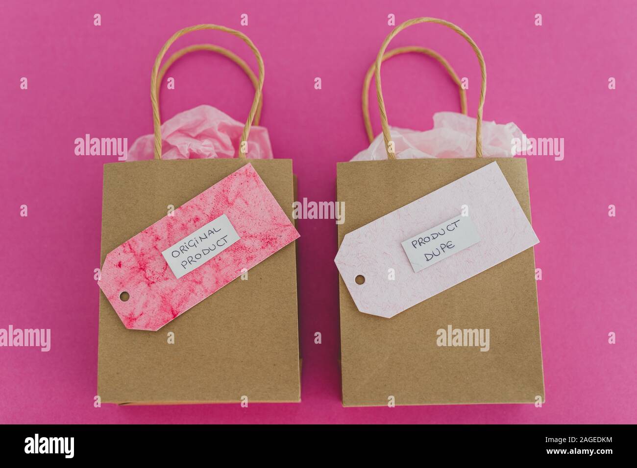 original product vs dupe imitation conceptual still-life, shopping bags  with labels side by side with similar paper color symbol of cheap product  alte Stock Photo - Alamy