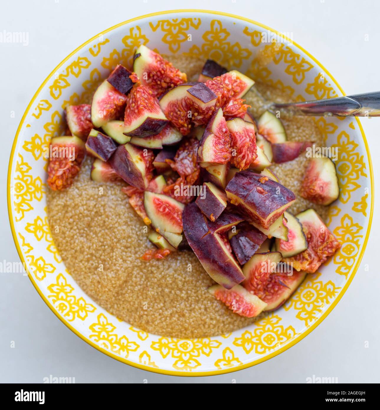 Gluten free amaranth porridge for breakfast with figs in a yellow bowl top view Stock Photo