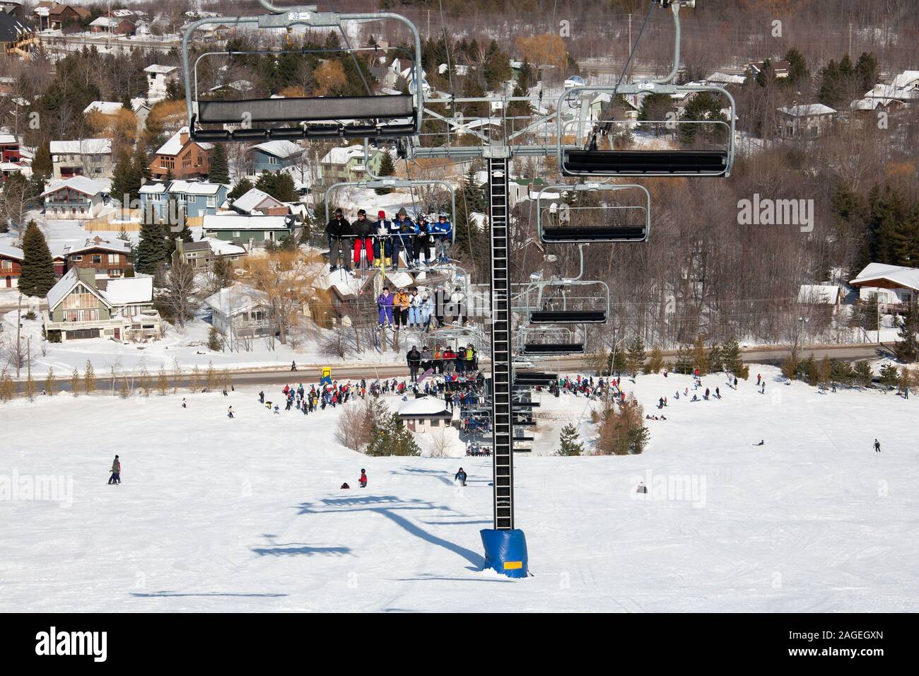 skiers and snowboarders are sitting on a ski cable chair lift Stock ...