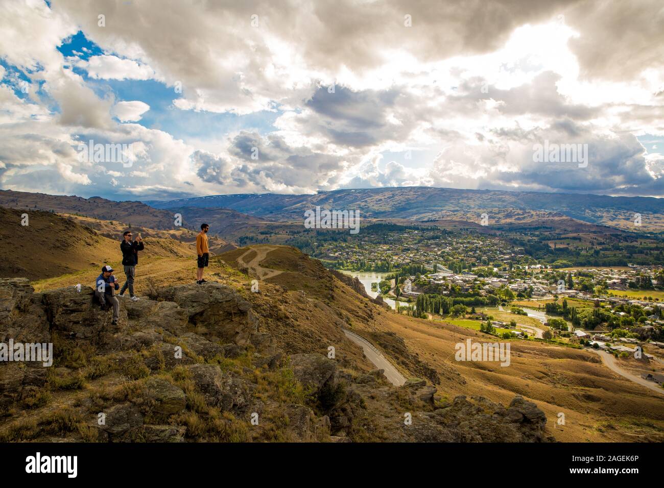 Alexandra, Otago, New Zealand, December 9 2019: tourists look out over Alexandra from the Lookout Point up on the surrounding cliffs Stock Photo