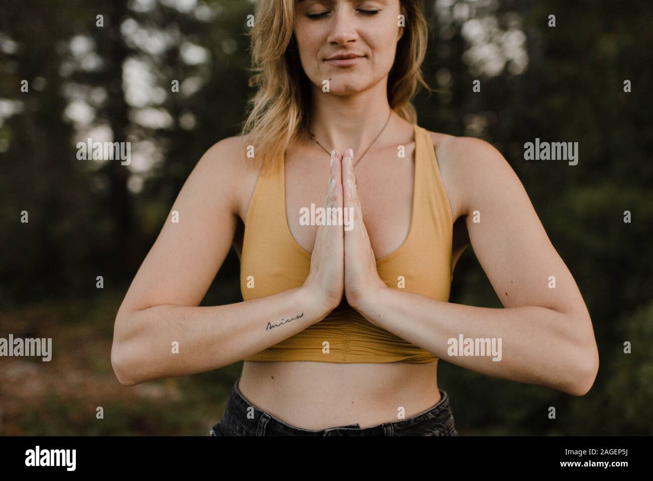 Woman practising yoga in forest Stock Photo