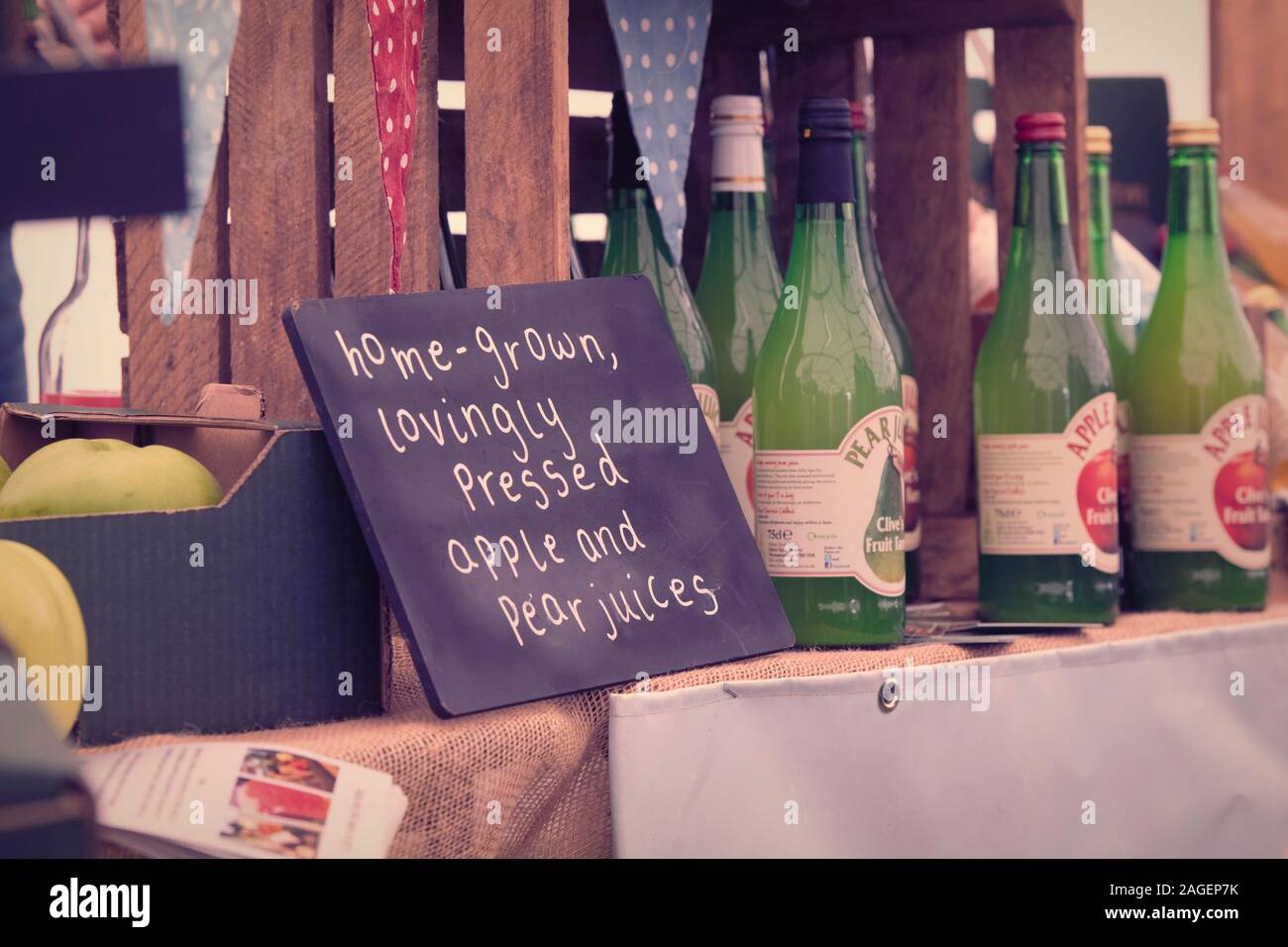 Home grown pear and apple juice sign on a display. UK. Vintage filter applied Stock Photo