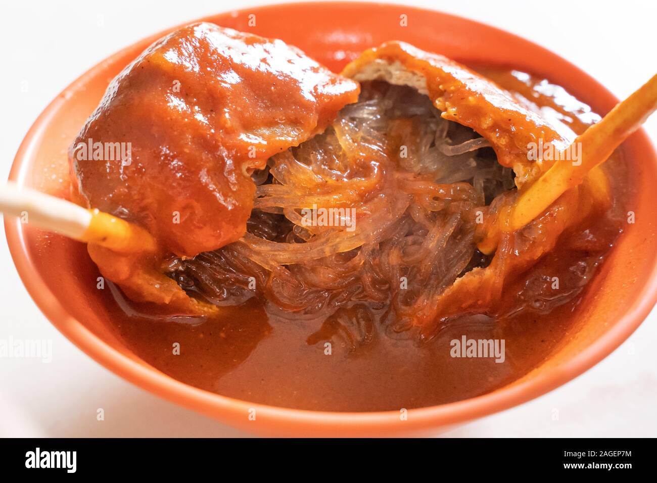 Tamsui agei (age, aburaage), delicious famous street food in Taipei, Taiwan, stuffed with mung bean noodles and chili sauce topping, lifestyle, close Stock Photo