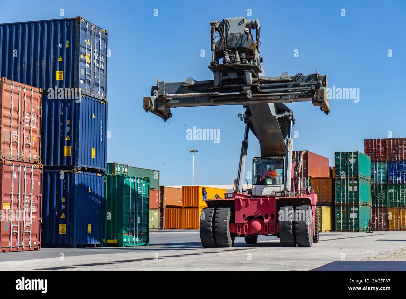 Reach stacker and shipping containers in dock Stock Photo Alamy