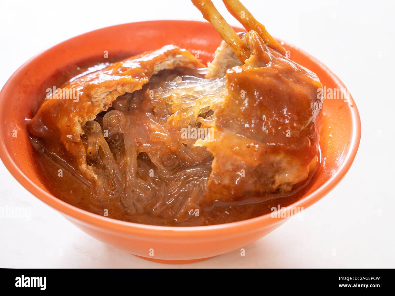 Tamsui agei (age, aburaage), delicious famous street food in Taipei, Taiwan, stuffed with mung bean noodles and chili sauce topping, lifestyle, close Stock Photo