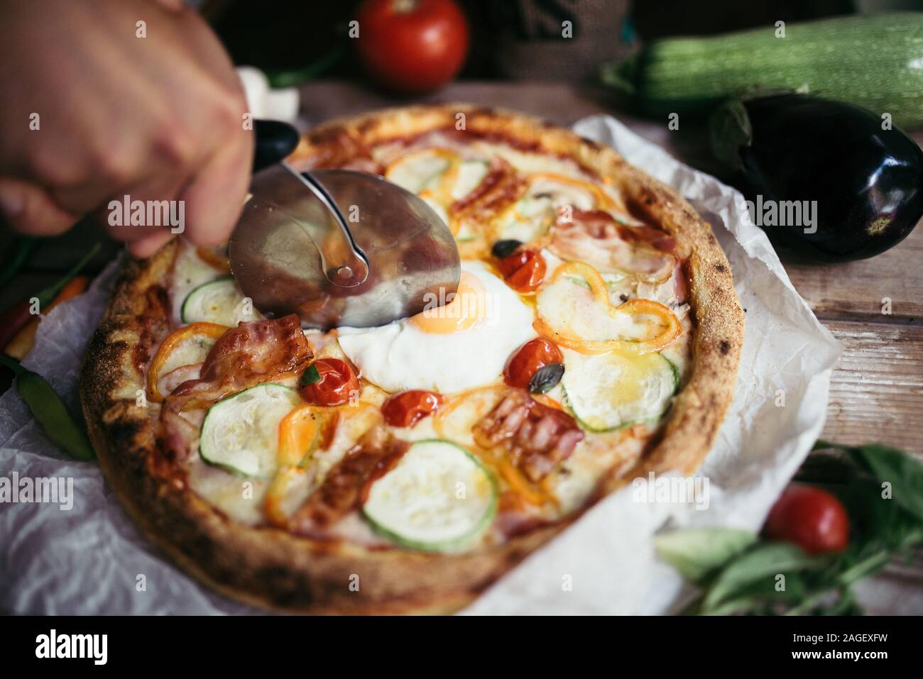 Sliced egg on the pizza in a restaruant. Stock Photo