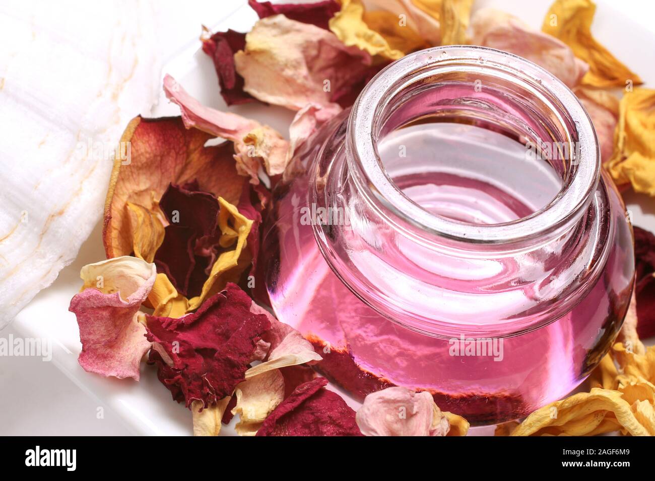 Wellness with massage oil, rose petals Stock Photo Alamy
