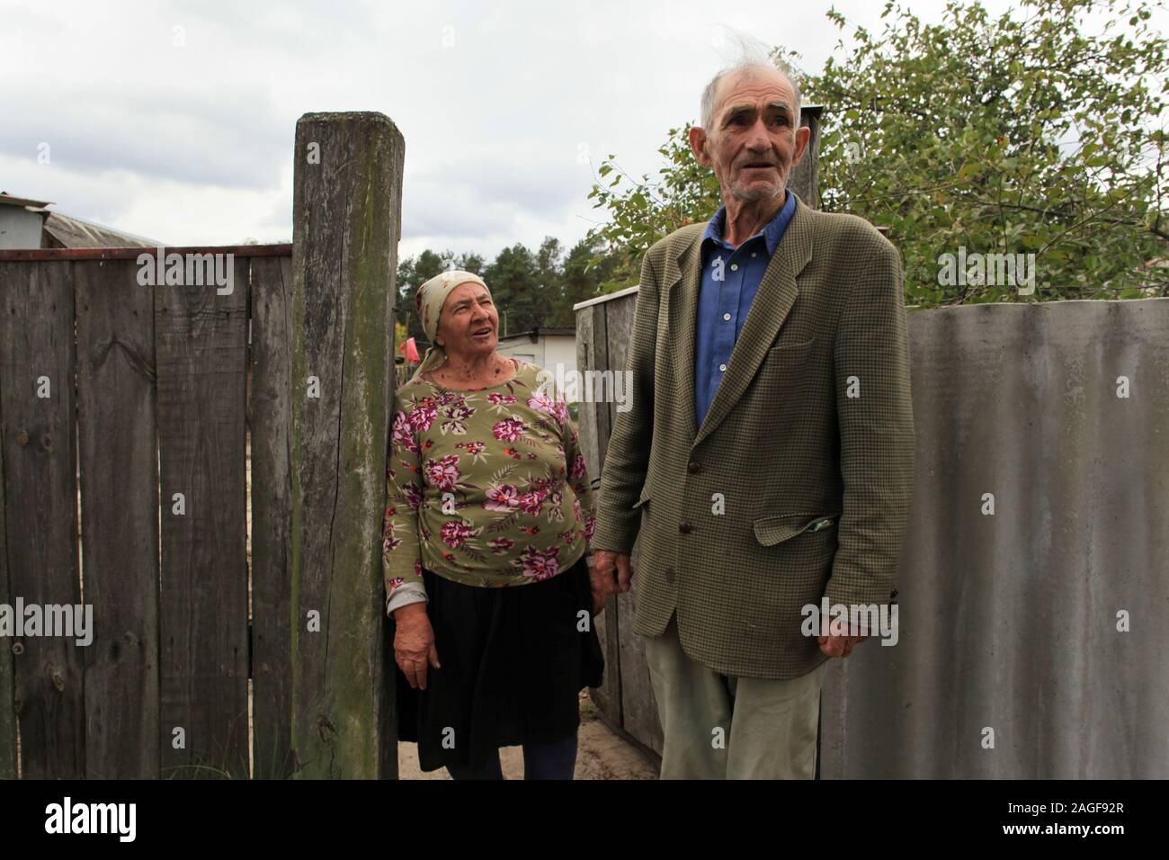 Ivan Ilchenko with his wife Maria in front of their farm in the village Kupovate, located in the Chernobyl Exclusion Zone. Both are illegal residents (Samosely), who returned some months after the evacuation of the Chernobyl Exclusion Zone (following the Chernobyl disaster in April 1986) at their farm. Kupovate, Chernobyl Exclusion Zone, Ivankiv Raion, Kiev Oblast, Ukraine, Eastern Europe Stock Photo