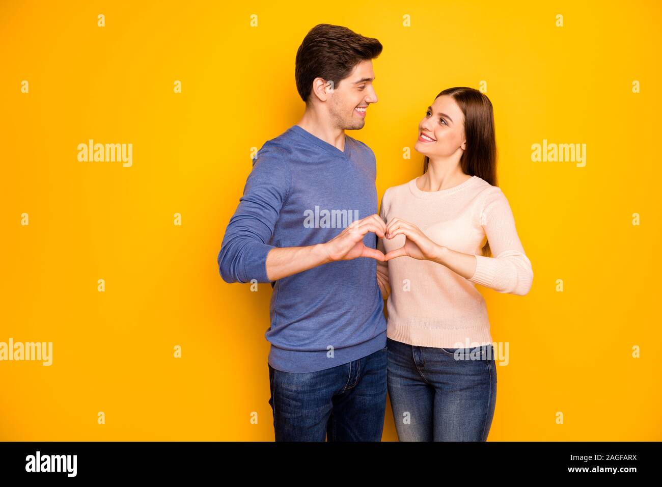 Love forever concept. Tender passionate two people spouses hug embrace make  heart finger look feel support wear modern outfit denim jeans isolated  Stock Photo - Alamy