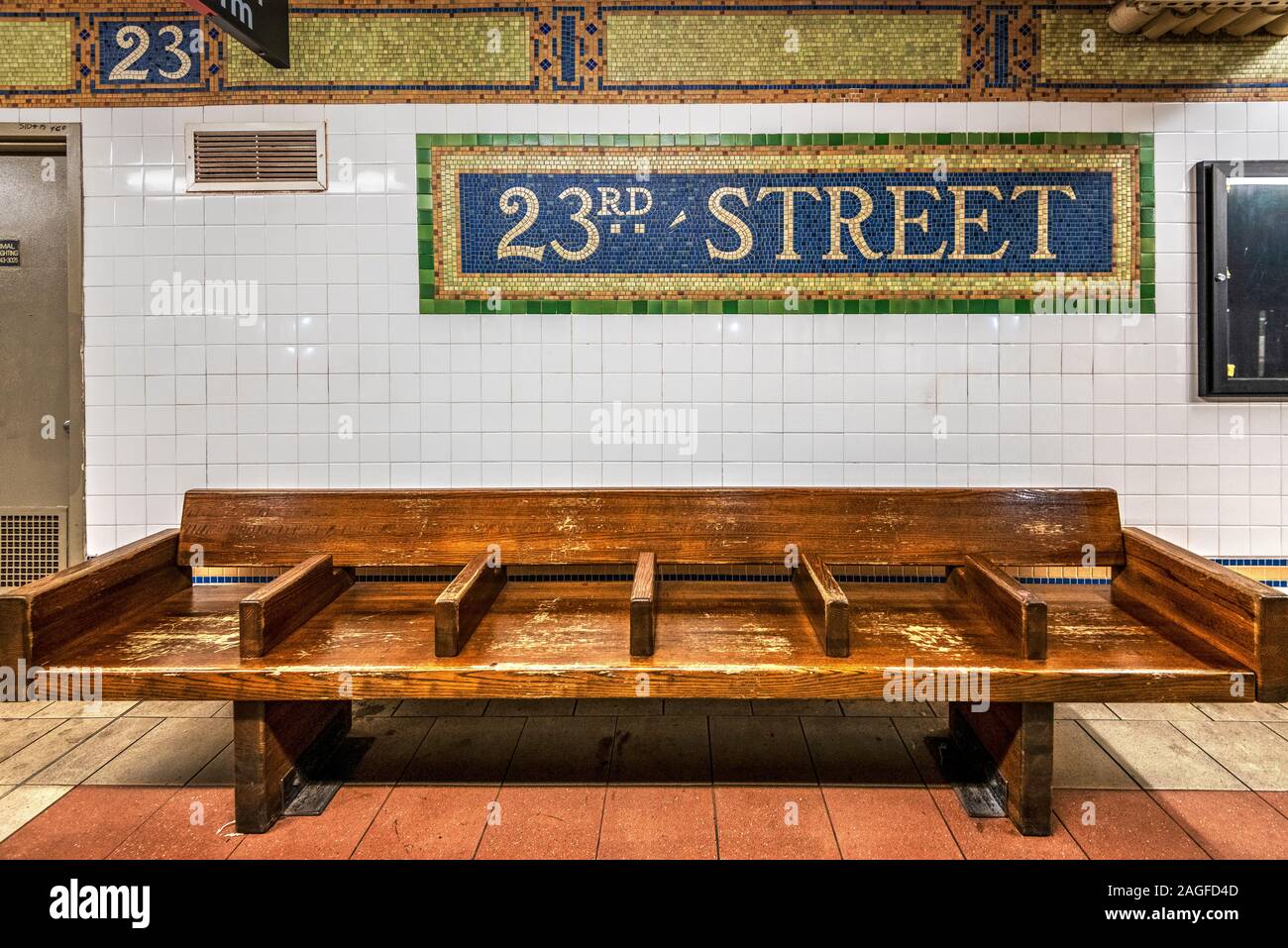 Old wooden bench and vintage subway sign at 23rd street subway station, Manhattan, New York, USA Stock Photo
