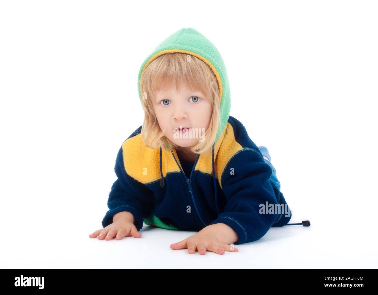 boy with long blond hair lying on the floor - isolated on white Stock Photo