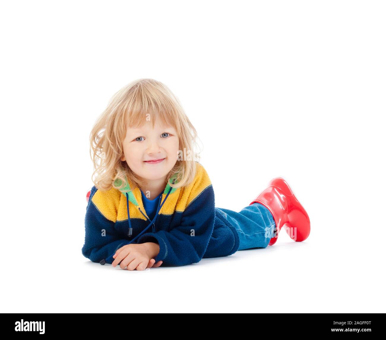 boy with long blond hair lying on the floor - isolated on white Stock Photo